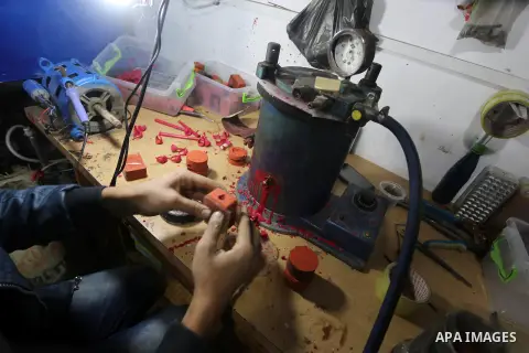 A Palestinian silver jeweler designs silver rings at his workshop in Gaza city on Dec. 16, 2015. Photo by Mohammed Asad