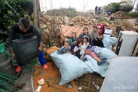 Palestinians inspect the home of the Ibrahim Diab and his daughter Dina was demolished by the Israeli military in the Sheikh Jarrah neighborhood of occupied East Jerusalem on Dec. 16, 2015. The home was 85 square meters...