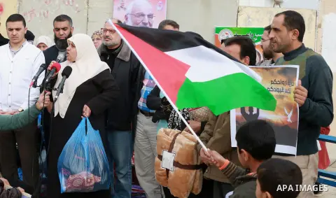 Relatives of Palestinian prisoners take part in a protest demanding to the entery of the winter clothing for their prisoners in Israeli jails, outside Eriz crossing in the northern Gaza Strip, on Dec. 17, 2015. Photo by...