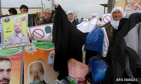 Relatives of Palestinian prisoners take part in a protest demanding to the entery of the winter clothing for their prisoners in Israeli jails, outside Eriz crossing in the northern Gaza Strip, on Dec. 17, 2015. Photo by...