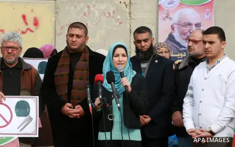 Relatives of Palestinian prisoners take part in a protest demanding to the entery of the winter clothing for their prisoners in Israeli jails, outside Eriz crossing in the northern Gaza Strip, on Dec. 17, 2015. Photo by...