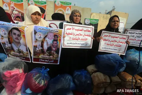 Relatives of Palestinian prisoners take part in a protest demanding to the entery of the winter clothing for their prisoners in Israeli jails, outside Eriz crossing in the northern Gaza Strip, on Dec. 17, 2015. Photo by...