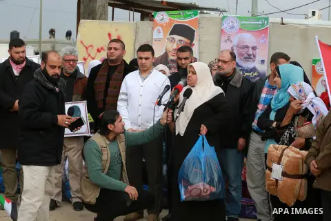 Relatives of Palestinian prisoners take part in a protest demanding to the entery of the winter clothing for their prisoners in Israeli jails, outside Eriz crossing in the northern Gaza Strip, on Dec. 17, 2015. Photo by...