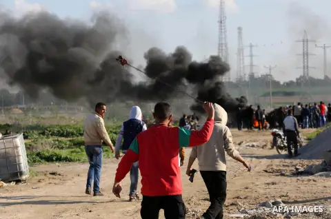 Palestinian protesters clash with Israeli security forces along the border with Israel in the eastern suburbs of Gaza City on December 18, 2015. A wave of violence has hit the Palestinian Territories, Jerusalem and Israe...