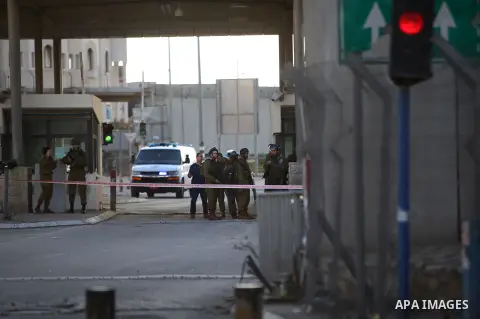Israeli security forces walk at the Qalandia checkpoint between Jerusalem and Ramallah in the Israeli occupied West Bank on December 18, 2015 after a Palestinian driver attempted to ram his vehicle into Israeli police an...