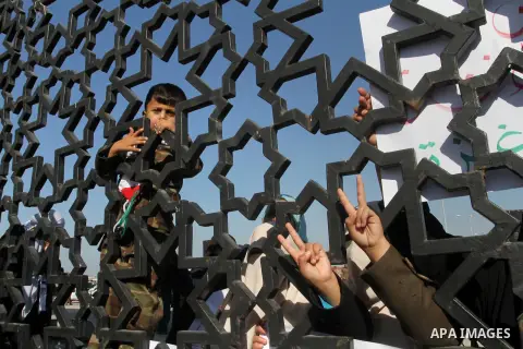 A Palestinian boy looks through the gate of Rafah border crossing during a rally calling on Egyptian authorities to open the crossing, in Rafah in the southern Gaza Strip December 22, 2015. Egypt has kept its Rafah cross...
