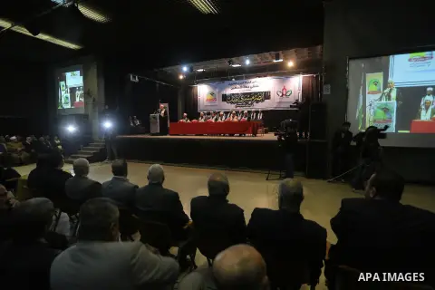 Palestinians watch while Ramadan Shallah, head of the Islamic jihad Movement speaking via a video link during a press conference, in Gaza City on Dec. 24, 2015. Photo by Mohammed Asad