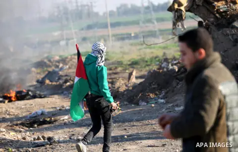 Palestinian protesters clash with Israeli security forces along the border fence with Israel on the eastern outskirts of Gaza City on December 25, 2015. A Palestinian was killed and around 40 were wounded in the clashes...