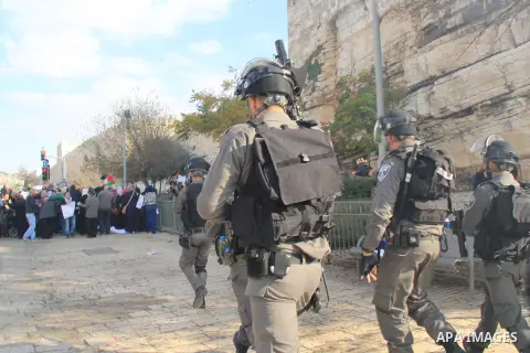 Israeli security forces stand guard and attempt to disperse Palestinian protesters outside Damascus Gate in Jerusalem's old city following a demonstration demanding Israeli authorities to return the bodies of alleged Pal...