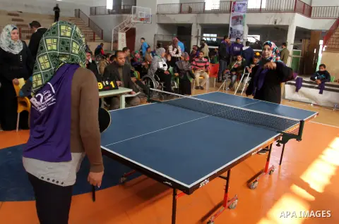 Disabled Palestinians play table tennis during the second Rachel Corrie Championship in Khan Younis in the southern Gaza strip on Dec. 30, 2015. Corrie, an American activist for the International Solidarity Movement (ISM...