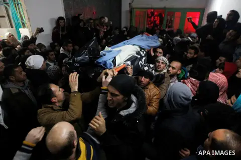 Palestinian men carry the body of a Palestinian alleged attacker upon its release by the Israeli security forces in the West Bank city of Hebron, on Jan. 01, 2016. Palestinians received on Friday 17 bodies of alleged ass...