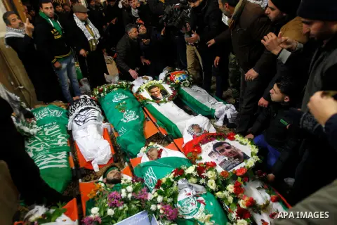 Mourners gather around the bodies of Palestinians, who allegedly carried out attacks against Israelis, during their funeral in the West Bank city of Hebron January 2, 2016. Palestinians received on Friday 23 bodies of al...