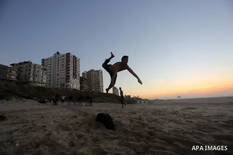 A member of Palestinian "3run Gaza" team, a street workout team practices his skills during parkour trainings at the beach of Gaza city on Jan. 05, 2016. Self-taught daredevils in the blockaded Gaza Strip are embracing a...