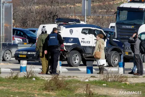 Israeli soldiers stand guard at the Gush Etzion junction in the Israeli occupied West Bank on the main road between Jerusalem and Hebron on January 5, 2016, after a Palestinian stabbed and wounded a soldier in the southe...