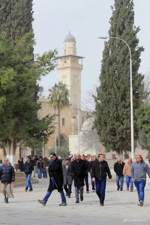 Palestinian Muslim worshipers walk in front of the Dome of the Rock mosque following Friday prayers at al-Aqsa mosque, Islam's third holiest site, in Jerusalem's Old city on Jan. 08, 2016. Photo by Mahfouz Abu Turk
