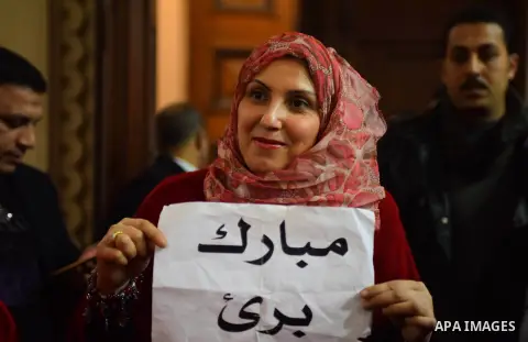 Egyptian supporters of ousted president Hosni Mubarak react inside the courtroom in Cairo on January 9, 2016, after top appeals court upheld upheld a three-year prison sentence for Mubarak and his two sons for corruption...