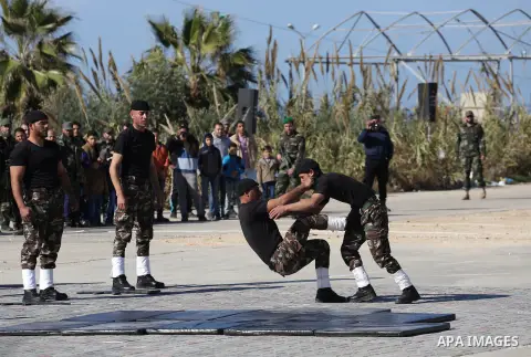 Members of Palestinian security forces loyal to Hamas demonstrate their skills during a military graduation ceremony in Gaza City January 10, 2016. Photo by Mohammed Asad