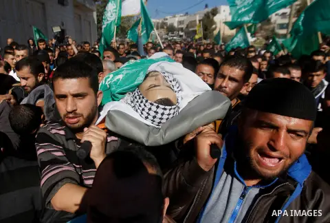 Mourners carry the body of Palestinian Mohammad Kawazbeh, who Israeli military said was shot dead by Israeli soldiers after he tried to stab a soldier on Tuesday, during his funeral in the West Bank village of Sae'er nea...