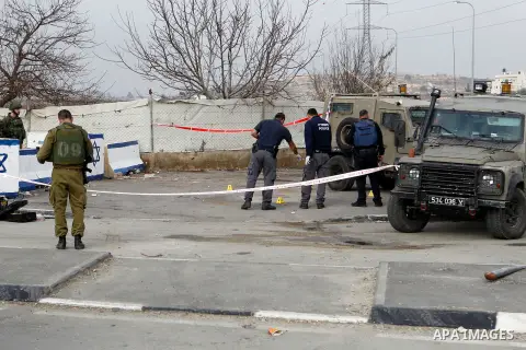 Israeli forensic policemen gather evidence at the site of a stabbing attack at the Beit Ainun junction near Hebron on January 14, 2016. Israeli forces Thursday shot and killed a Palestinian near the Beit Ainun junction n...