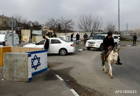 Israeli forensic policemen gather evidence at the site of a stabbing attack at the Beit Ainun junction near Hebron on January 14, 2016. Israeli forces Thursday shot and killed a Palestinian near the Beit Ainun junction n...