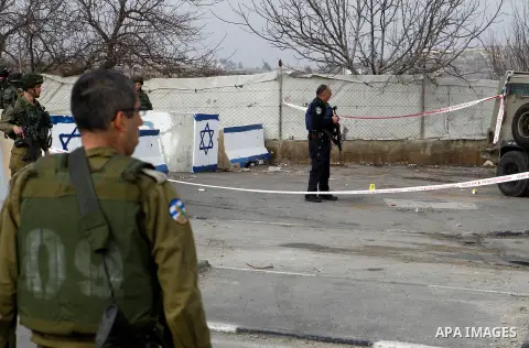 An Israeli forensic policeman gathers evidence at the site of a stabbing attack at the Beit Ainun junction near Hebron on January 14, 2016. Israeli forces Thursday shot and killed a Palestinian near the Beit Ainun juncti...