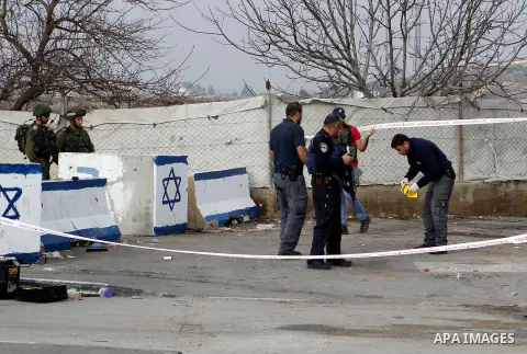 Israeli forensic policemen gather evidence at the site of a stabbing attack at the Beit Ainun junction near Hebron on January 14, 2016. Israeli forces Thursday shot and killed a Palestinian near the Beit Ainun junction n...