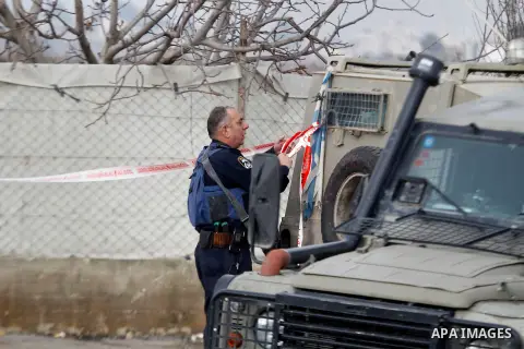 An Israeli forensic policeman gathers evidence at the site of a stabbing attack at the Beit Ainun junction near Hebron on January 14, 2016. Israeli forces Thursday shot and killed a Palestinian near the Beit Ainun juncti...