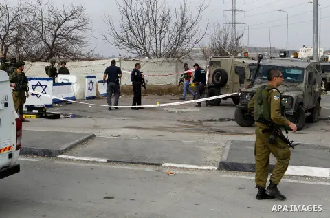 Israeli forensic policemen gather evidence at the site of a stabbing attack at the Beit Ainun junction near Hebron on January 14, 2016. Israeli forces Thursday shot and killed a Palestinian near the Beit Ainun junction n...
