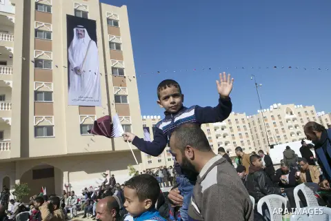 Palestinians gather at the Qatari-funded Hamad City housing complex in Khan Younis, southern Gaza Strip, Saturday, Jan. 16, 2016. More than 1,000 Palestinian families have taken possession of new apartments in the first...