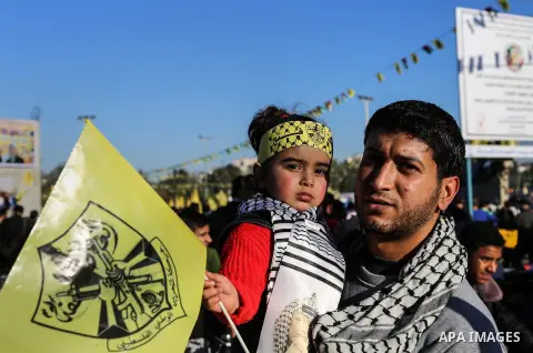 Palestinian Fatah supporters celebrate during a rally as they mark the 51st anniversary of the founding of the Fatah movement, in Beit Lahia in the northern Gaza Strip, on Jan. 17, 2016. Photo by Nidal Alwaheidi