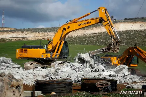 An Israeli bulldozer demolishes a Palestinian house under the order of the Israeli army, in the West Bank town of Dura, south of Hebron January 20, 2016. The owners of the house said they were informed by the Israeli arm...