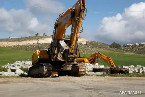 An Israeli bulldozer demolishes a Palestinian house under the order of the Israeli army, in the West Bank town of Dura, south of Hebron January 20, 2016. The owners of the house said they were informed by the Israeli arm...