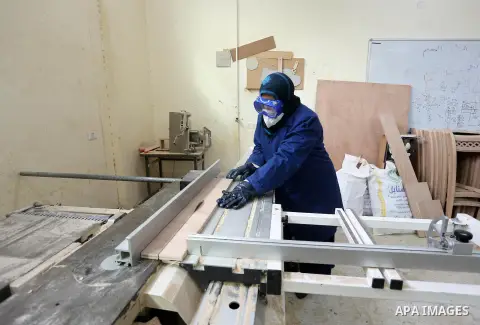 A Palestinian disabled works on wood to makes furniture during participate in a project titled "Erada" funded by the Turkish President Ragab Ardogan at the Islamic university, in Gaza City, on January 20, 2016. Photo by...
