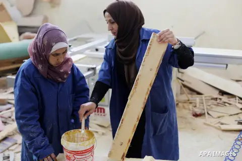 Palestinians disabled work on wood to make furniture during participate in a project titled "Erada" funded by the Turkish President Ragab Ardogan at the Islamic university, in Gaza City, on January 20, 2016. Photo by Moh...