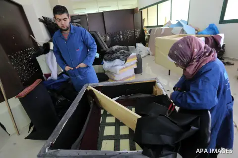 Palestinians disabled work on wood to make furniture during participate in a project titled "Erada" funded by the Turkish President Ragab Ardogan at the Islamic university, in Gaza City, on January 20, 2016. Photo by Moh...