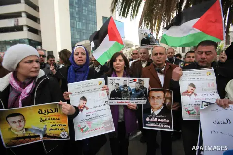 Palestinians take part in a demonstration demanding the release of Palestinian journalist Mohammed al-Qiq from Israeli jails, in the West Bank city of Nablus on Jan. 21, 2016. Qiq, a 33-year-old reporter for Saudi TV cha...