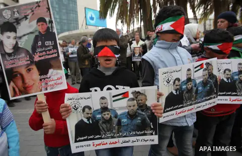Palestinians take part in a demonstration demanding the release of a 13-year-old Ahmed Manasra, from Israeli jails, in the West Bank city of Nablus on Jan. 21, 2016. Israeli police have accused Manasra, together with his...