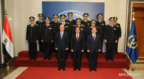 Egyptian President Abdel-Fattah el-Sissi poses for a photo with families of policemen killed in militant attacks, at a ceremony marking Police Day, which falls on Jan. 25, the anniversary of the 2011 uprising that topple...