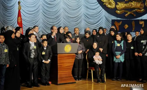Egyptian President Abdel-Fattah el-Sissi poses for a photo with families of policemen killed in militant attacks, at a ceremony marking Police Day, which falls on Jan. 25, the anniversary of the 2011 uprising that topple...