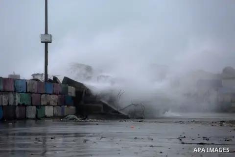 A huge wave is seen crash over a sea wall at the Gaza seaport during a rainy day, in Gaza City, January 24, 2016. Photo by Mohammed Asad