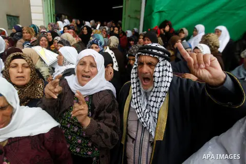 Palestinians carry the body of Ruqya Abu Eid, 13, during her funeral, who Israeli military said was shot dead by Israeli soldiers after he tried to stab a soldier, in the West Bank city of Hebron, on January, 24, 2016. P...