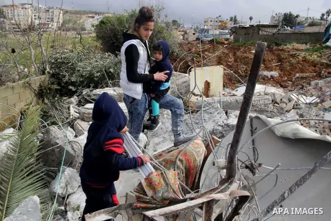 Palestinians look at the rubble of their house that was demolished by Israeli bulldozerst, in the Arab east Jerusalem neighbourhood of Shuafat on January 27, 2016. Palestinian homes built without an Israeli construction...
