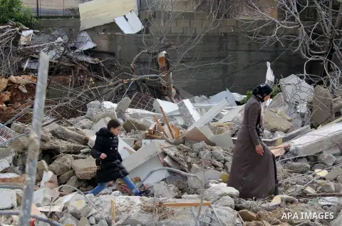 Palestinians look at the rubble of their house that was demolished by Israeli bulldozerst, in the Arab east Jerusalem neighbourhood of Shuafat on January 27, 2016. Palestinian homes built without an Israeli construction...