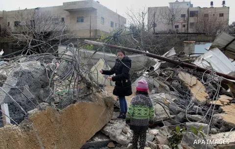 Palestinians look at the rubble of their house that was demolished by Israeli bulldozerst, in the Arab east Jerusalem neighbourhood of Shuafat on January 27, 2016. Palestinian homes built without an Israeli construction...