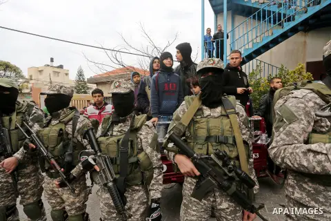 Palestinian members of Ezzedeen al-Qassam, the armed wing of Hamas movement, take part during the funeral of Palestinian Hamas militants whom killed after a tunnel, built for fighting Israel, collapsed in the Gaza Strip,...