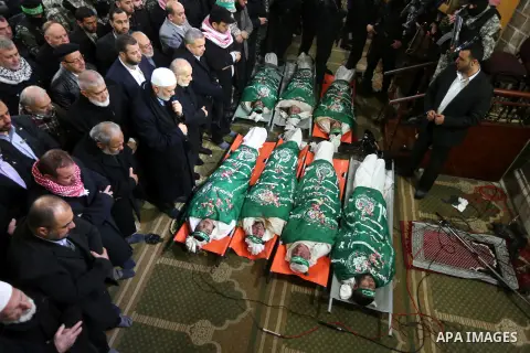 Palestinians pray at a mosque near the bodies of the seven Palestinian Hamas militants whom killed after a tunnel, built for fighting Israel, collapsed in the Gaza Strip, during their funeral in Gaza City on January 29,...