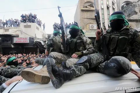 Palestinian members of Ezzedeen al-Qassam, the armed wing of Hamas movement, take part during the funeral of Palestinian Hamas militants whom killed after a tunnel, built for fighting Israel, collapsed in the Gaza Strip,...