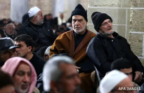 Palestinians pray at a mosque near the bodies of the seven Palestinian Hamas militants whom killed after a tunnel, built for fighting Israel, collapsed in the Gaza Strip, during their funeral in Gaza City on January 29,...