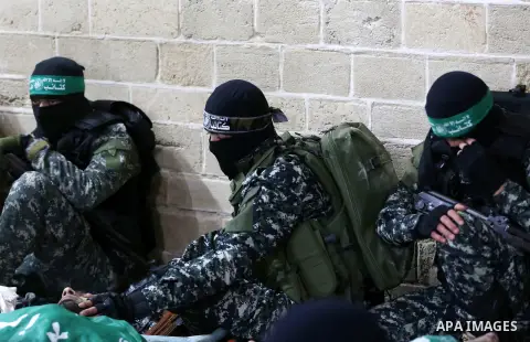 Palestinian Hamas militants and mourners gather around the bodies of seven Hamas militants killed after a tunnel, built for fighting Israel, collapsed in the Gaza Strip, during their funeral in Gaza City on January 29, 2...