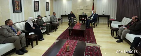 Palestinian Prime Minister Rami Hamdallah meets with the family of Palestinian journalist Mohammed al-Qiq who is on hunger strike in an Israeli jail for 68 days in the West Bank city of Ramallah on Jan. 31, 2016. Photo b...